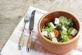 Vegetarian Greek salad with feta cheese, arugula, olives and cherry tomatoes and italian herbs in clay bowl Royalty Free Stock Photo