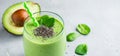 Vegetarian healthy green smoothie from avocado, spinach leaves, apple and chia seeds in glass on gray concrete background. Selecti Royalty Free Stock Photo