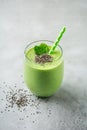 Vegetarian healthy green smoothie from avocado, spinach leaves, apple and chia seeds on gray concrete background. Selective focus Royalty Free Stock Photo