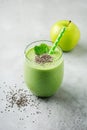 Vegetarian healthy green smoothie from avocado, spinach leaves, apple and chia seeds on gray concrete background. Selective focus Royalty Free Stock Photo