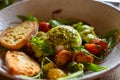 Vegetarian italian food, fresh vegetables salad with white soft burrata cheese and green pesto Royalty Free Stock Photo