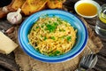 Vegetarian Italian Pasta Spaghetti Aglio E Olio with garlic bread, red chili flake, parsley, parmesan cheese and glas of water Royalty Free Stock Photo