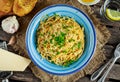 Vegetarian Italian Pasta Spaghetti Aglio E Olio with garlic bread, red chili flake, parsley, parmesan cheese and glas of water Royalty Free Stock Photo