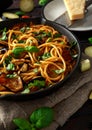 Vegetarian Italian Pasta Spaghetti alla Norma with eggplant, tomatoes, basil and parmesan cheese in rustic skillet pan. Royalty Free Stock Photo