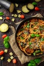 Vegetarian Italian Pasta Spaghetti alla Norma with eggplant, tomatoes, basil and parmesan cheese in rustic skillet pan. Royalty Free Stock Photo