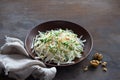 Vegetarian Jerusalem artichoke topinambour salad with apple, walnut and greens on a dark wooden background