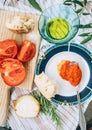 Vegetarian low-calorie still life with red tomatoes ,olive oil, garlic, onion and big spoon of AJVAR - traditional Balkans