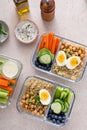 Vegetarian lunch meal prep containers high protein with quinoa, herbed chickpeas, vegetables and eggs