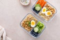 Vegetarian lunch meal prep containers high protein with quinoa, herbed chickpeas, vegetables and eggs