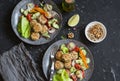 Vegetarian lunch - quinoa meatballs and vegetable salad on a dark table