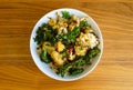 Vegetarian meal with oven roasted cauliflower, kale, and red bell peppers over brown rice