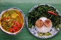 Vegetarian meal, rice dish with boiled water morning glory, vegan sausage, sour soup bowl Royalty Free Stock Photo