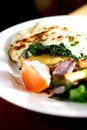 Vegetarian meal of spinach on German potato cake Royalty Free Stock Photo