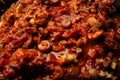 Vegetarian mushrooms chickpea stew in a iron pan on a dark background, top view