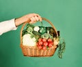 Vegetarian nutrition concept. Farmer holds cabbage, radish, pepper, broccoli, carrot