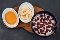 Vegetarian oatmeal porridge with dried red berries, banana and honey Royalty Free Stock Photo