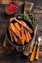 Vegetarian Oven baked sweet potato fries. Dark wooden background. Top view