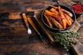 Vegetarian Oven baked sweet potato fries. Dark wooden background. Top view. Copy space