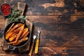 Vegetarian Oven baked sweet potato fries. Dark wooden background. Top view. Copy space