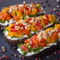 Baked eggplants stuffed with vegetable, walnut and cream cheese on a black slate background, close up