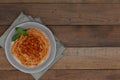 Vegetarian pasta stewed beans in tomato sauce on wood background.