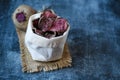 Vegetarian pile of healthy beet chips Purple Baked Beet Chips Vegan snacks, vegetable chips in canvas bag and ceramic bowl, rustic