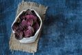 Vegetarian pile of healthy beet chips Purple Baked Beet Chips Vegan snacks, vegetable chips in canvas bag and ceramic bowl, rustic