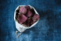 Vegetarian pile of healthy beet chips Purple Baked Beet Chips Vegan snacks, vegetable chips in canvas bag and ceramic bowl, rustic