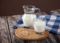 Vegetarian pine nut milk in a glass cup and jug, on a wooden stand with a blue linen napkin Royalty Free Stock Photo