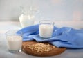 Vegetarian pine nut milk in glass cups and jug and blue linen napkin on white background. horizontal Royalty Free Stock Photo