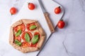 Vegetarian pizza galette with feta cheese, spinach and tomato