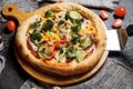 Vegetarian pizza with greens and broccoli, zucchini and pepper. Slimming pizza.