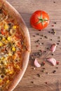 Vegetarian pizza, ingredients and spices on rustic wooden board background Royalty Free Stock Photo