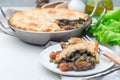 Vegetarian pot pie with lentil, mushrooms, potato, carrot and green peas, covered with puff pastry, on white plate, horizontal, Royalty Free Stock Photo
