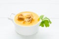 Vegetarian pumpkin soup with dry bread nd parsley in white bowl Royalty Free Stock Photo