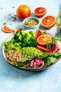 Vegetarian Quinoa bowl. Healthy breakfast or snack with detox quinoa with vegetables, avocado, blood orange, broccoli, watermelon Royalty Free Stock Photo