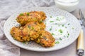 Vegetarian quinoa, carrot, coriander and green onion fritters served with yogurt
