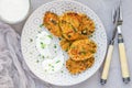 Vegetarian quinoa, carrot, coriander and green onion fritters served with yogurt on a plate, horizontal, top view Royalty Free Stock Photo