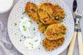 Vegetarian quinoa, carrot, coriander and green onion fritters served with yogurt on plate, horizontal, top view Royalty Free Stock Photo