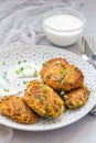 Vegetarian quinoa, carrot, coriander and green onion fritters served with yogurt, vertical