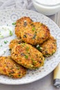 Vegetarian quinoa, carrot, coriander and green onion fritters served with yogurt, vertical