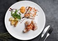 Vegetarian Rolls with shiitake mushrooms and shrimps decorated with baby spinach