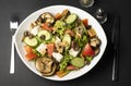Vegetarian Salad of eggplant Halloumi, fresh tomatoes, lettuce, cucumber and nuts in top view