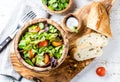 Vegetarian salad with lettuce and tomatoes in olive wooden bowl