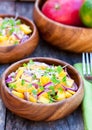 Vegetarian salad with mango oranges and red onion on the wooden Royalty Free Stock Photo