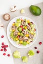 Vegetarian salad from romanesco cabbage, champignons, cranberry, avocado and pumpkin on a white wooden background. top view Royalty Free Stock Photo