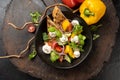 Vegetarian salad of vegetables, onions, cherry tomatoes, red and yellow bell peppers and greens with mozzarella cheese. Royalty Free Stock Photo
