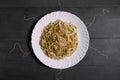 Vegetarian Schezwan Noodles or Vegetable Hakka Noodles or Chow Mein in white plate at wooden background. Schezwan Noodles is indo-