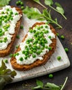 Vegetarian seeded sourdough bread open sandwich with cottage cheese and petit poit peas sprinkled with chilli flakes