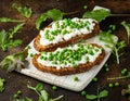 Vegetarian seeded sourdough bread open sandwich with cottage cheese and petit poit peas sprinkled with chilli flakes